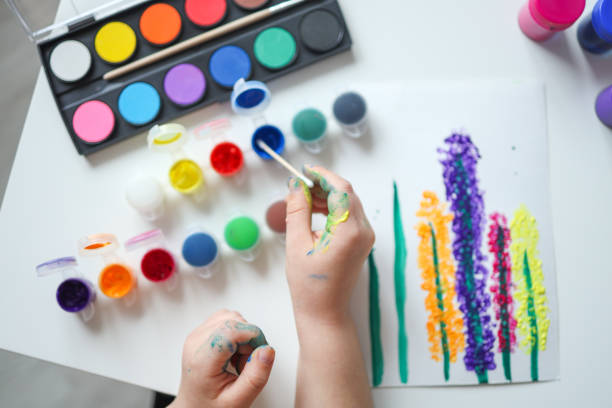 istock Children's drawing with paints top view, hands with paints 1485463024