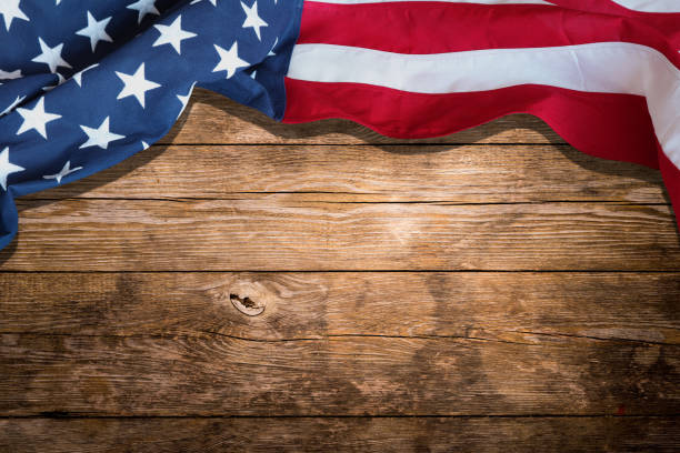 USA flag on wooden table, USA flag top view from table, USA flag display on the wooden table on top view, Make Your Independence Day Memorable with the American Flag stock photo