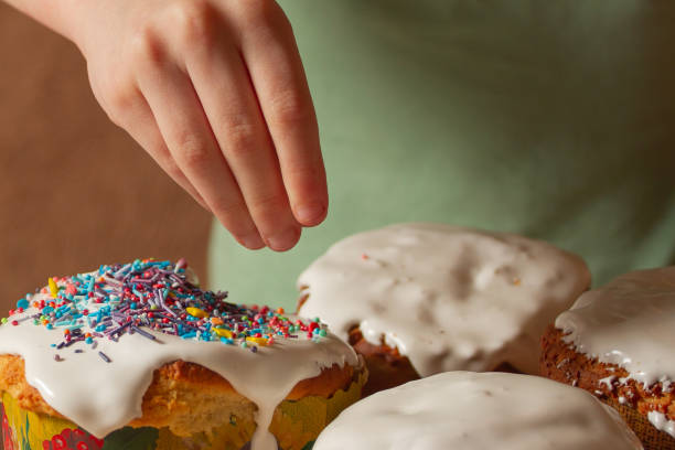 istock a child, a boy at home in the kitchen decorates an Easter cake. 1485463512