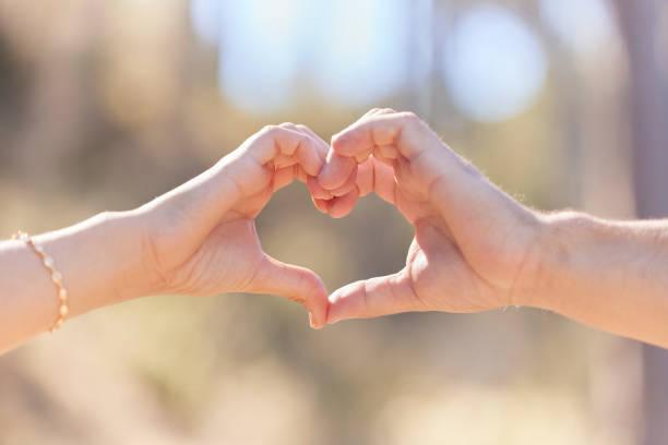 istock Heart hands, nature and love, support and commitment partnership for marriage outdoors. Valentines day, romance and couple, man and woman with emoji for care, relationship and affection or trust. 1485463998