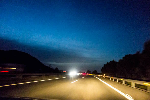 istock Driving car on a highway at night 1485470703