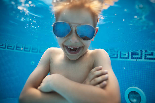 istock Cool boy wearing mirrored sunglasses underwater 1485471986