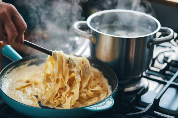 istock Preparing Fettuccine Pasta Alfredo with Parmesan 1485472480