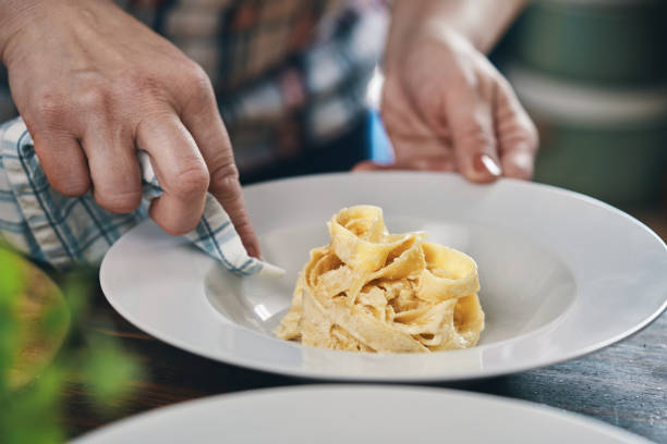 istock Preparing Fettuccine Pasta Alfredo with Parmesan 1485472611