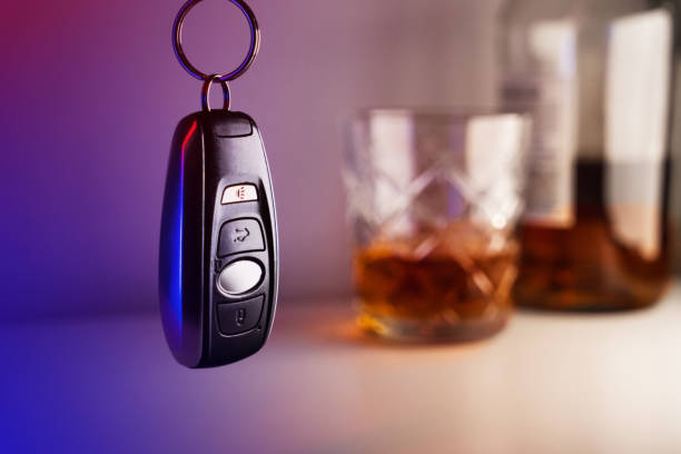 llaves del coche con vidrio y botella de licor, concepto de no beber y conducir - conductor asignado fotografías e imágenes de stock