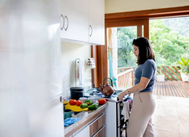 Young woman cooking in kitchen at home