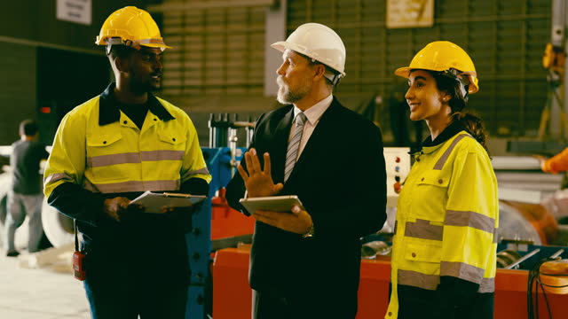 A group of manufacturing workers inspecting items