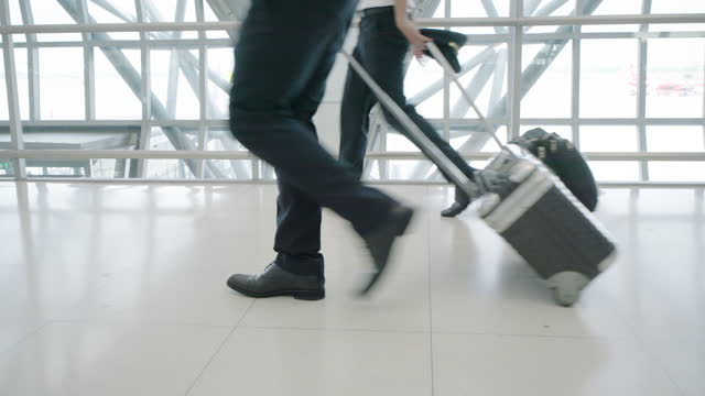 Passenger dragging luggage to the terminal at the airport