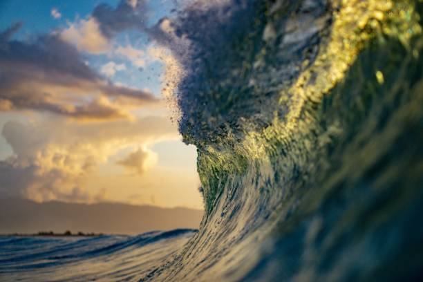 istock close up view of ocean wave breaking into sunset on beach 1485482593