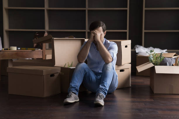 Stressed frustrated former home owner leaving flat stock photo