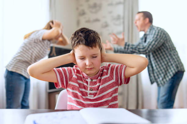 istock Sad child covers his ears with his hands during an argument between his parents 1485491184