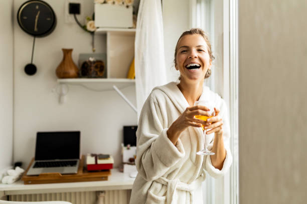 istock Young woman at home drinking coffee wearing robe looking at camera 1485494937