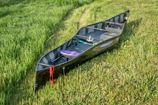 racing tandem canoe, carbon fiber construction, on a grassy area