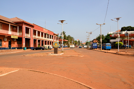 Bissau, Guinea-Bissau: view along Amilcar Cabral Avenue, former Republic Avenue, the city's main street - 'Armazens do Povo' on the left and Galp/Petrogal petrol station on the right. Rotary International cogwheel in the center.