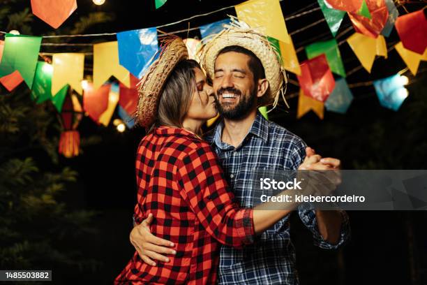 Brazilian Couple Wearing Traditional Clothes For Festa Junina June Festival Dancing Under The Night Sky Stock Photo - Download Image Now
