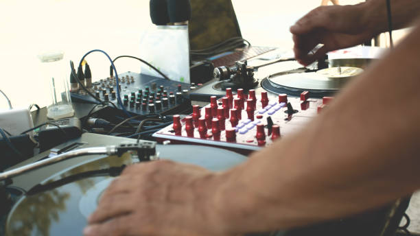 istock DJ's Hand on Turntable Playing Vinyl Record in Club 1485506032