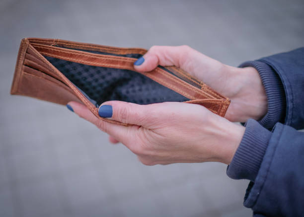 istock Woman holding empty brown wallet 1485515880