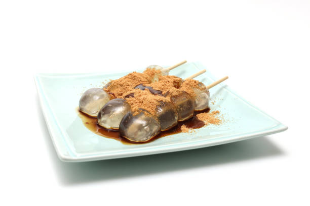 Brown sugar taste warabi mochi with soybean flour on a plate.