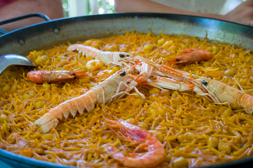 Close up view of an authentic Fideua shellfish and shrimp paella from valencia. (Is a Delicious shellfish Paella of noodles) Spain