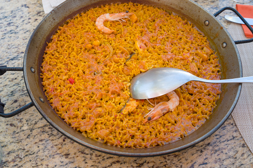 Seafood paella by the swimming pool in summer Alicante Spain