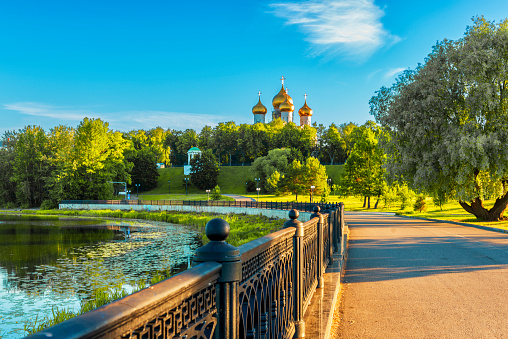 Park recreation area in the city of Yaroslavl. Embankment along the river Kotorosl. In the distance you can see the domes of the Assumption Cathedral, one of the sights of the city.