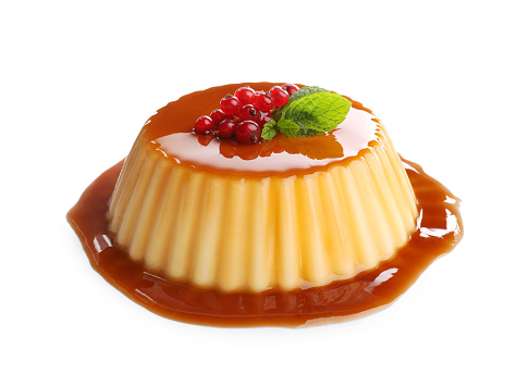 Delicious pudding with caramel, redcurrants and mint isolated on white