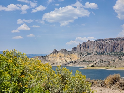 This is a photograph taken on a mobile phone outdoors of the Blue Mesa Reservoir in Curecanti national recreation area landscape during the summer of 2020 in Gunnison, Colorado.