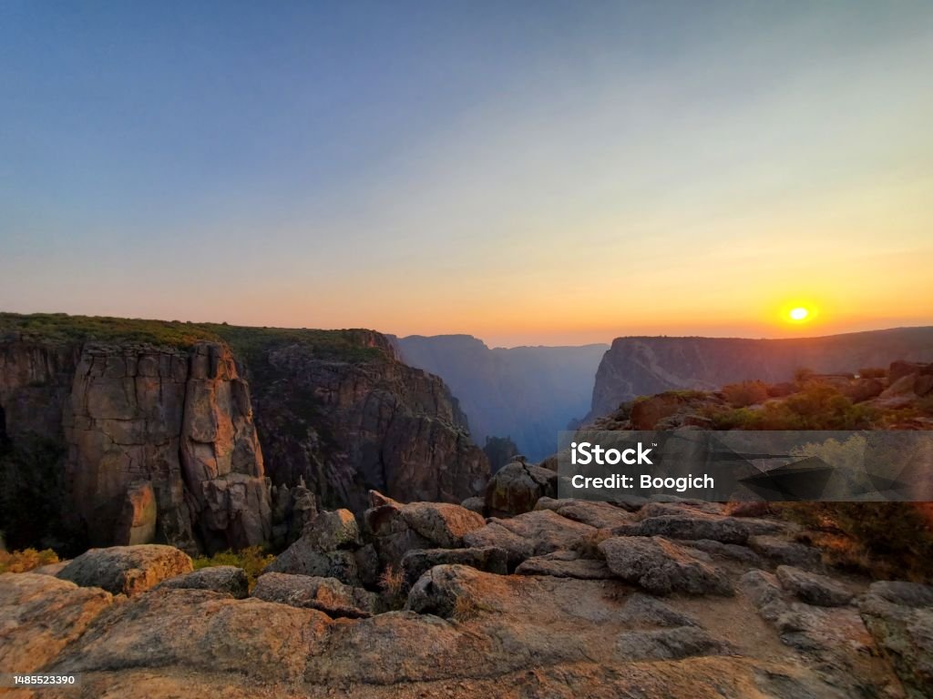 Sunset Over Black Canyon of the Gunnison National Park Colorado USA This is a photograph taken on a mobile phone outdoors of sunset over the landscape of Black Canyon of the Gunnison National Park in summer of 2020 in, Colorado USA. Colorado Stock Photo