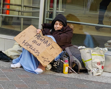 Pregnant and homeless young white woman at downtown Boston