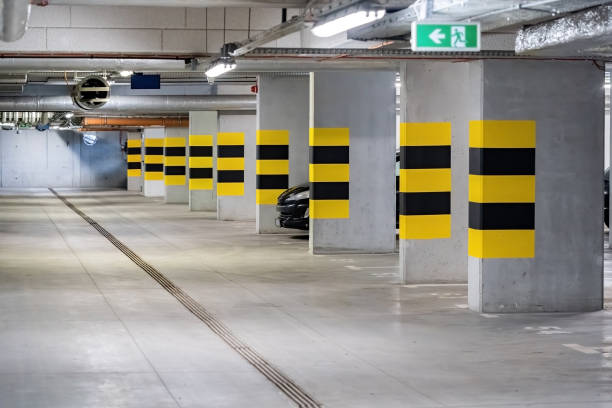 istock Empty underground parking lot under a modern apartment complex flat, one generic car parked, nobody, no people, lots of free parking space New real estate parking spots buying business, simple concept 1485532195