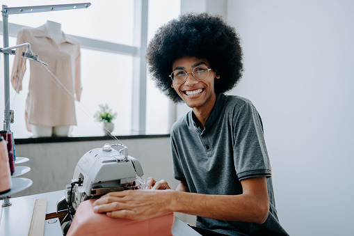 A young man sewing sewing machine