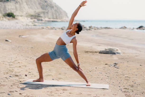 istock Young woman exercise on the beach 1485534652