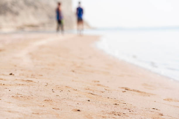 Young couple doing exercise together on the beach
