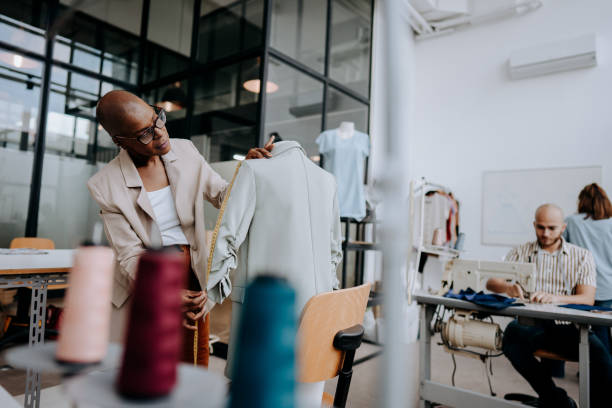 istock Woman measuring clothes on mannequin at sewing workshop 1485535312