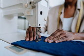 Unrecognizable person sewing using sewing machine