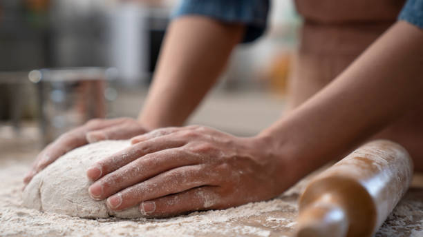 istock Woman hands kneading dough in the kitchen 1485535432