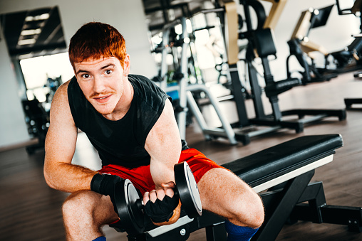 man with dumbell at the gym