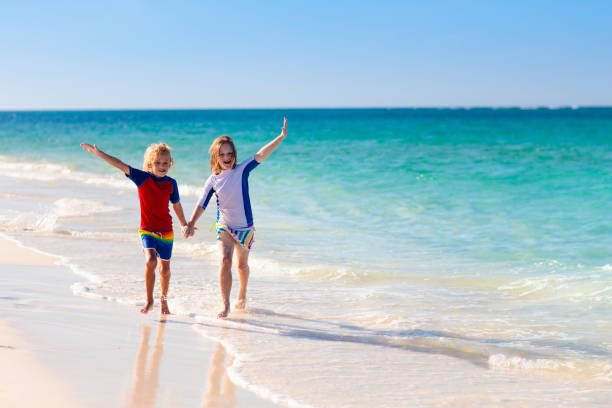 istock Kids playing on beach. Children play at sea. 1485537484