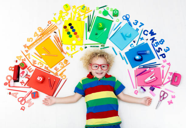 istock Child with school and drawing supplies. Student with book. 1485538255