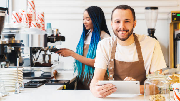 istock Smiling employees are working together coffee shop 1485538886