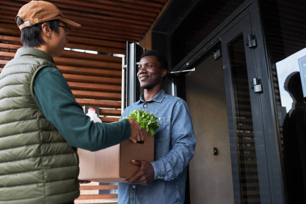 istock Black man accepting grocery delivery outdoors and smiling 1485541737