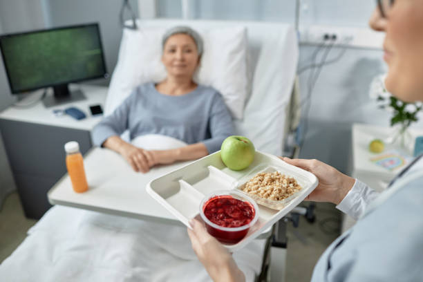 istock Nurse serving food for sick patient 1485542666