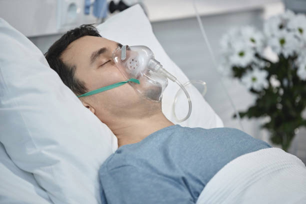 istock Patient with oxygen mask lying in hospital ward 1485542717