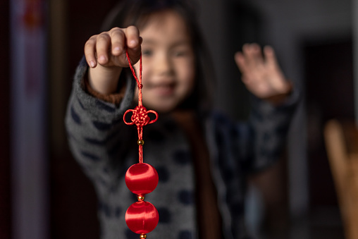 A Chinese girl holding a Chinese lantern to congratulates the middle and new year
