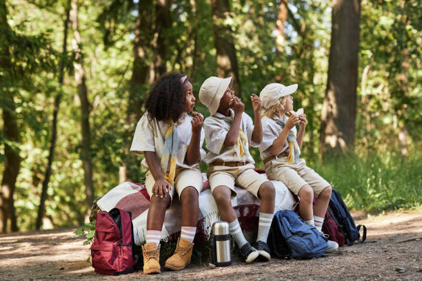 istock Diverse group of scouts enjoying lunch break in forest 1485545054
