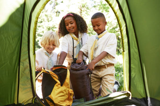 istock Diverse group of young scouts putting up tent in forest 1485546188
