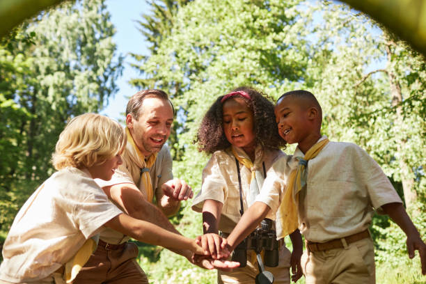 istock Diverse group of scouts stacking hands and huddling 1485546211