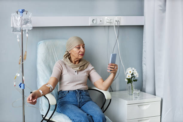 istock Senior woman with IV drip using smartphone 1485546418