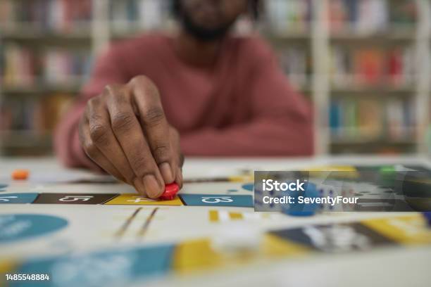 Closeup Of Black Man Playing Board Game Stock Photo - Download Image Now - Board Game, Adult, Leisure Games