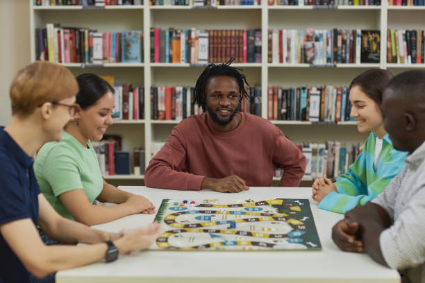 Group of young people playing board games together